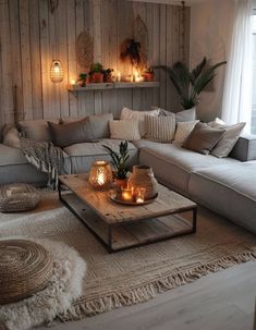 a living room filled with lots of furniture and candles on top of it's coffee table