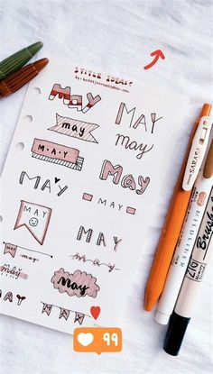 some markers and pens are on top of a sheet of paper that says may, may, may