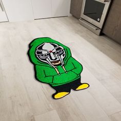 a rug with a cartoon character on it in the middle of a kitchen floor next to an oven