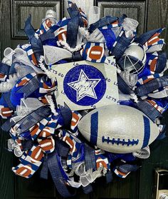 a football wreath on the front door with blue, white and orange ribbons around it