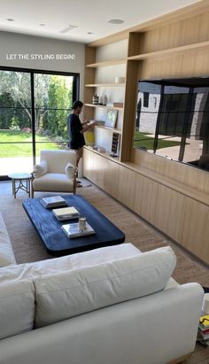 a living room filled with furniture and a flat screen tv sitting on top of a wall