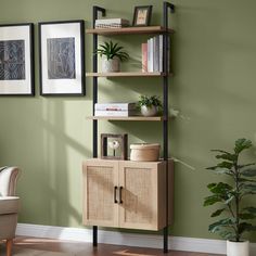 a living room with green walls and a book shelf filled with books on top of it