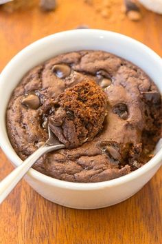 a chocolate cookie in a bowl with a spoon