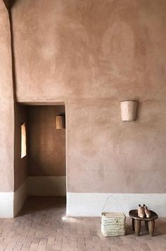 a pair of shoes sitting on the floor in front of a wall with an open door