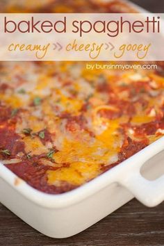 baked spaghetti casserole with creamy cheesy gooey sauce in a white dish