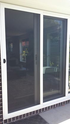 an open sliding glass door on the outside of a house