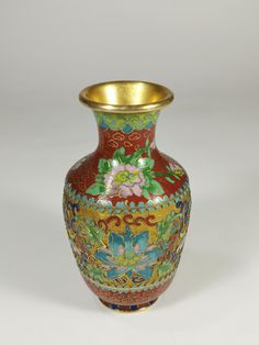 a vase with flowers painted on it