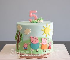 a birthday cake with pep the pig on top and five year candles in the shape of numbers