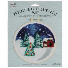 needle felting kit featuring a christmas scene with a tree and a house in the snow