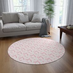 a living room with a white couch and pink rug in front of a large window