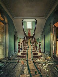 an abandoned building with stairs leading up to the second floor that has been torn apart