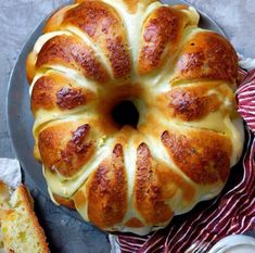 a bundt cake sitting on top of a plate next to a slice of bread