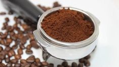 coffee beans and ground coffee on a white plate