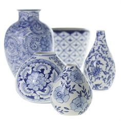 four blue and white vases sitting next to each other