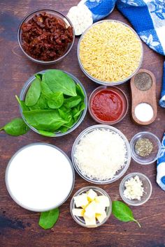 the ingredients to make an italian pasta dish laid out on a wooden table