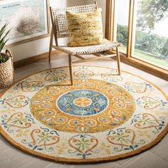 an area rug in the corner of a room with a chair and potted plant