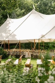 an outdoor tent set up with tables and chairs