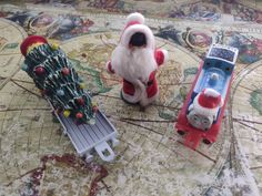 two toy cars with santa claus and a christmas tree