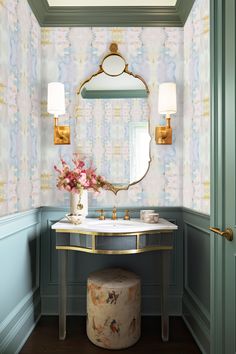 a bathroom with a vanity, mirror and flowers on the table in front of it