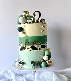 a three tiered cake decorated with animals and balloons