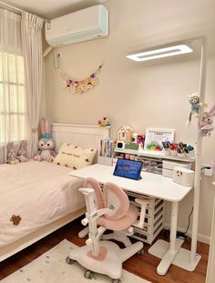 a child's bedroom with a bed, desk and computer