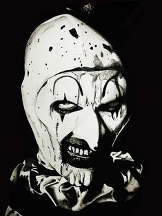 an image of a scary clown with his face painted black and white in the dark