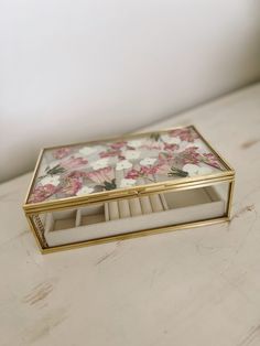 a box with flowers on it sitting on a table