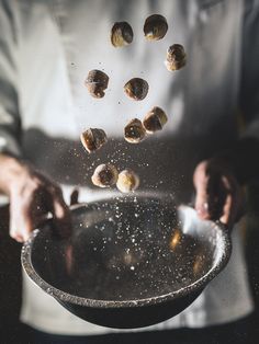 a chef is sprinkling nuts into a bowl