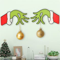 two green hands hanging from the ceiling with christmas decorations