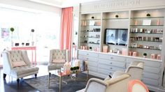 a living room filled with furniture and a flat screen tv sitting on top of a wall