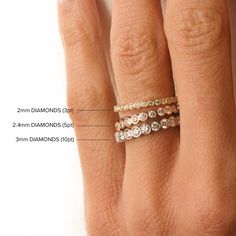 a woman's hand with three different rings on her finger and the measurements for each ring