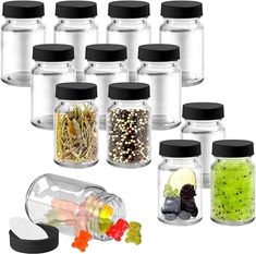 six clear jars with black lids and various candies in them