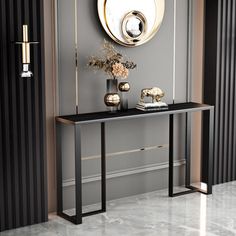 a black and gold console table in front of a mirror