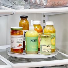 jars of food are sitting on the shelf in the refrigerator