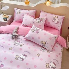 a hello kitty bed set with pink polka dots and teddy bear on the comforter