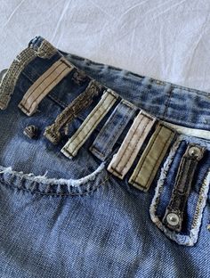 an old pair of jeans with holes in the back pocket and zippers on them