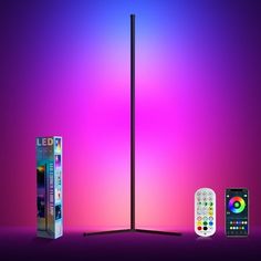 an electronic device with remote controls next to it on a purple and pink background,