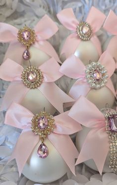 some pink and white ornaments with bows on them