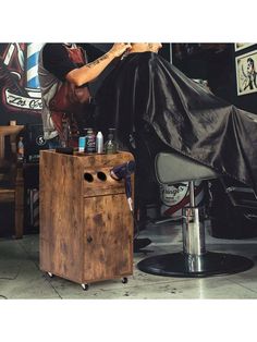 a man getting his hair cut at a barbershop in front of a chair