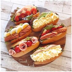 there are many hot dogs with toppings on the plate