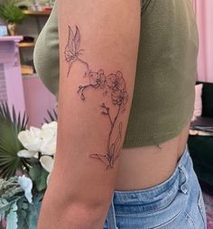 a woman's arm with a flower tattoo on the left side of her body