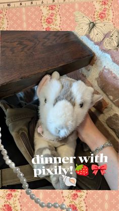 a stuffed animal is sitting under a table with the words dinner with pixly on it