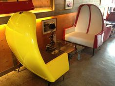 two yellow chairs sitting next to each other in a room