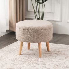 a round ottoman sitting on top of a rug