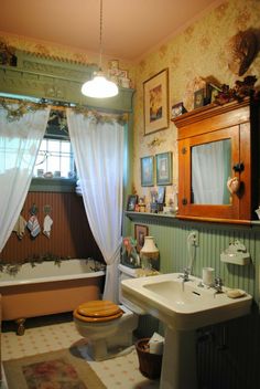 a bathroom with a toilet, sink, and bathtub in the middle of it