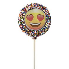 a smiley face lollipop with sprinkles on it