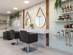 a hair salon with chairs and mirrors on the wall