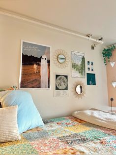 a bed room with a neatly made bed and pictures on the wall