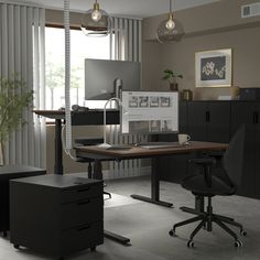 an office area with desk, chair and computer monitor on top of the wooden table