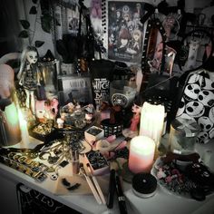 a table topped with lots of different types of items and candles on top of it